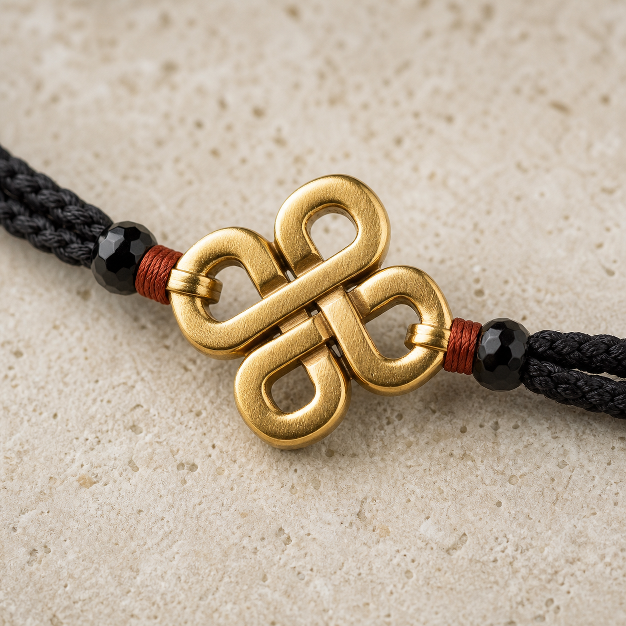 Close view of obsidian, woven cord, and gold vermeil
