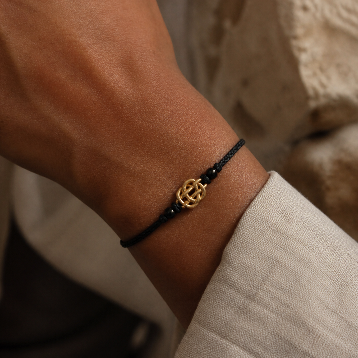 Guardian Knot Bracelet worn with a pale neutral sleeve